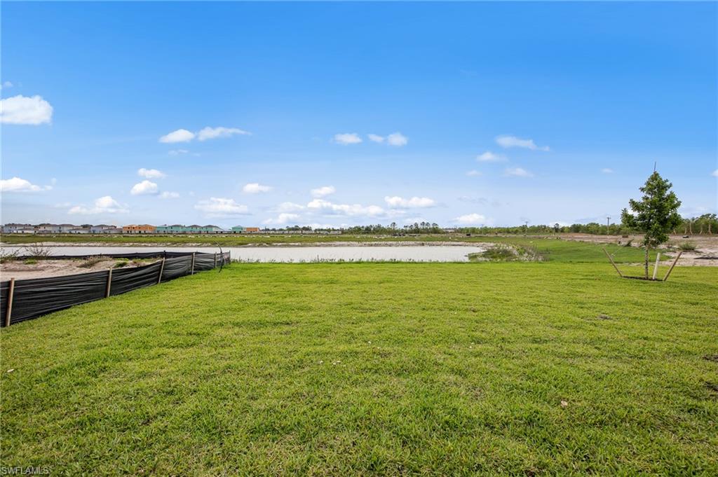 12265 Savanna Lakes Boulevard Lehigh Acres, FL 33936 - Photo 26 of 31 View of yard featuring a water view