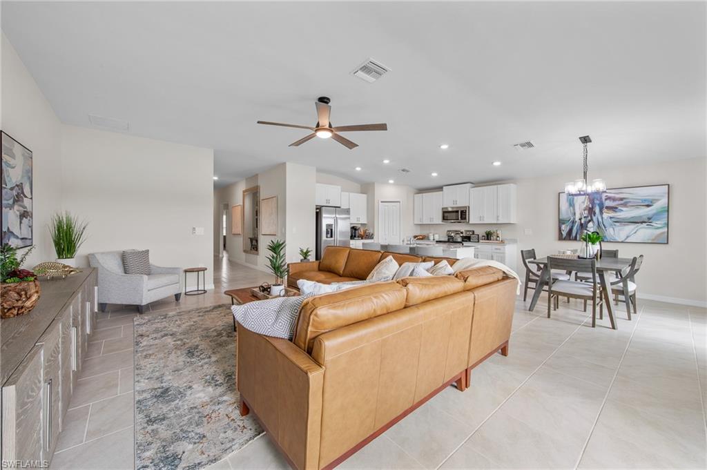 12265 Savanna Lakes Boulevard Lehigh Acres, FL 33936 - Photo 8 of 31 Living area featuring ceiling fan, light tile patterned floors, recessed lighting, and a chandelier