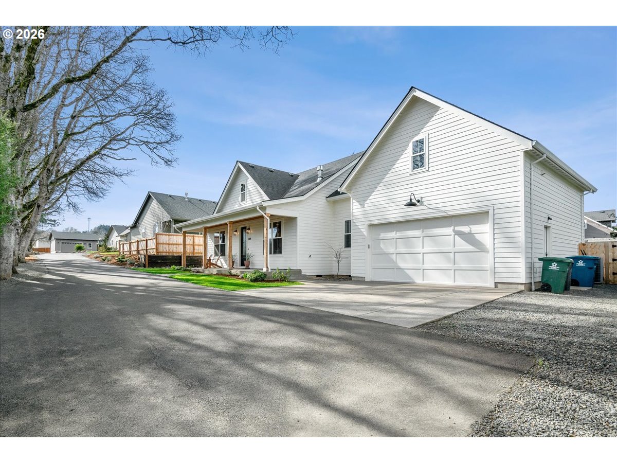 1305 Uff Da Street Silverton, OR 97381 - Photo 2 of 46 a front view of a house with a yard and garage