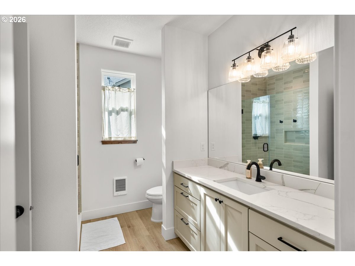 1305 Uff Da Street Silverton, OR 97381 - Photo 26 of 46 a bathroom with a sink a toilet and a mirror