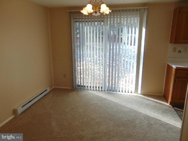 3623 Carrollton Road Upperco, MD 21155 - Photo 9 of 20 a view of an empty room with a fireplace and a window