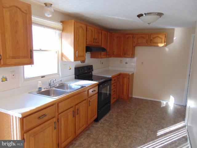 3623 Carrollton Road Upperco, MD 21155 - Photo 10 of 20 a kitchen with stainless steel appliances granite countertop a sink stove and cabinets