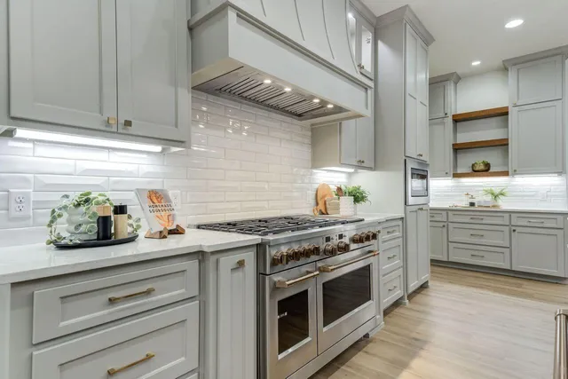 a kitchen with granite countertop a stove and cabinets