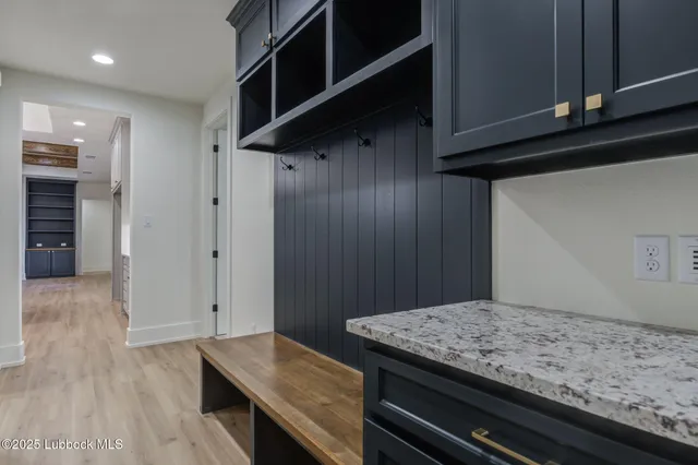 a kitchen with stainless steel appliances granite countertop a sink and dishwasher with white cabinets