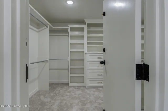 a utility room with a sink and a mirror