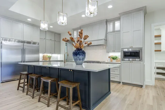a kitchen with granite countertop a sink cabinets and stainless steel appliances