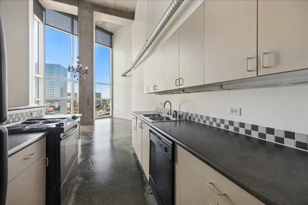 a kitchen with granite countertop a stove and a sink