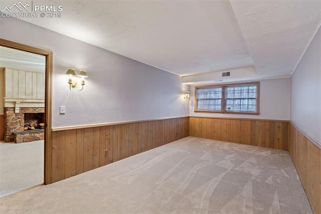 34 Upland Road Colorado Springs, CO 80906 - Photo 30 of 34 Basement bedroom next to family room in the basement. Fresh paint and carpeting