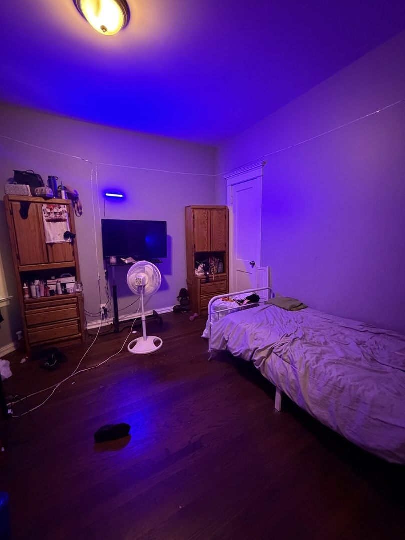 6156 South Indiana Avenue Chicago, IL 60637 - Photo 17 of 21 a bedroom with bed and a couch