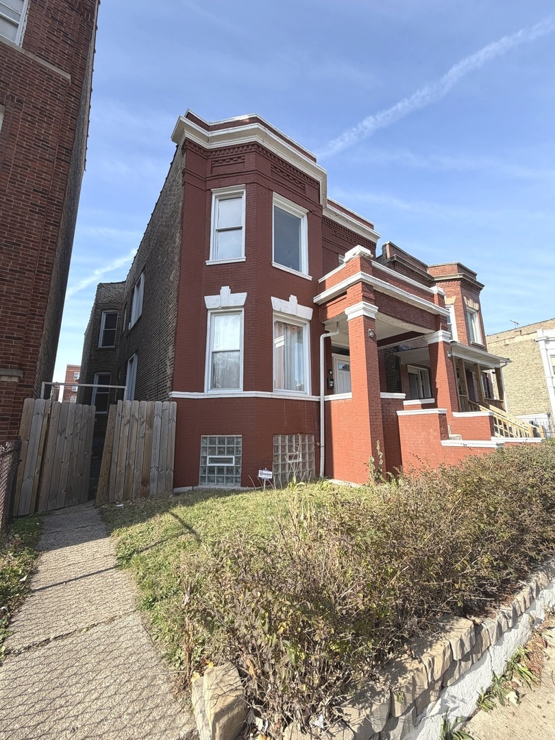 6156 South Indiana Avenue Chicago, IL 60637 - Photo 2 of 21 a front view of a house with a yard