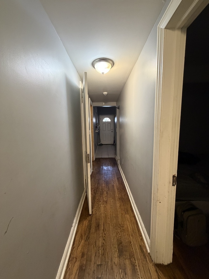6156 South Indiana Avenue Chicago, IL 60637 - Photo 8 of 21 a view of a hallway with wooden floor