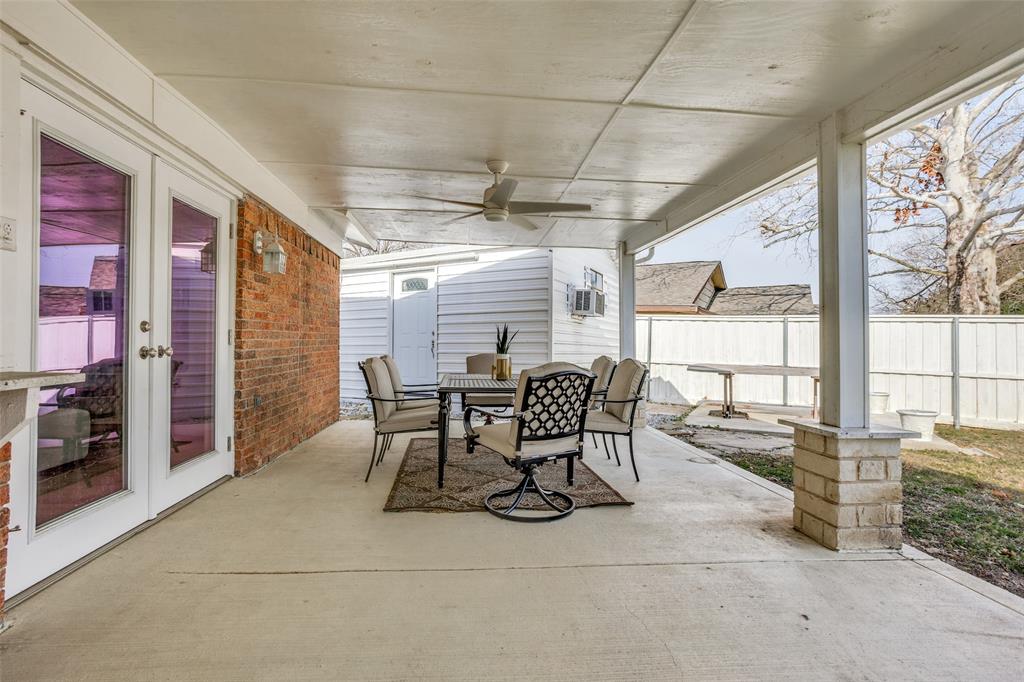5702 Galaxie Road Garland, TX 75044 - Photo 16 of 21 Expansive covered patio with ample room for both lounging and dining, creating the perfect setting for year-round outdoor living.