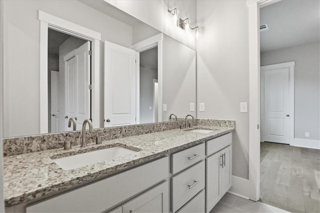 216 Ewing Way Dacula, GA 30019 - Photo 47 of 80 a bathroom with a granite countertop sink and a mirror