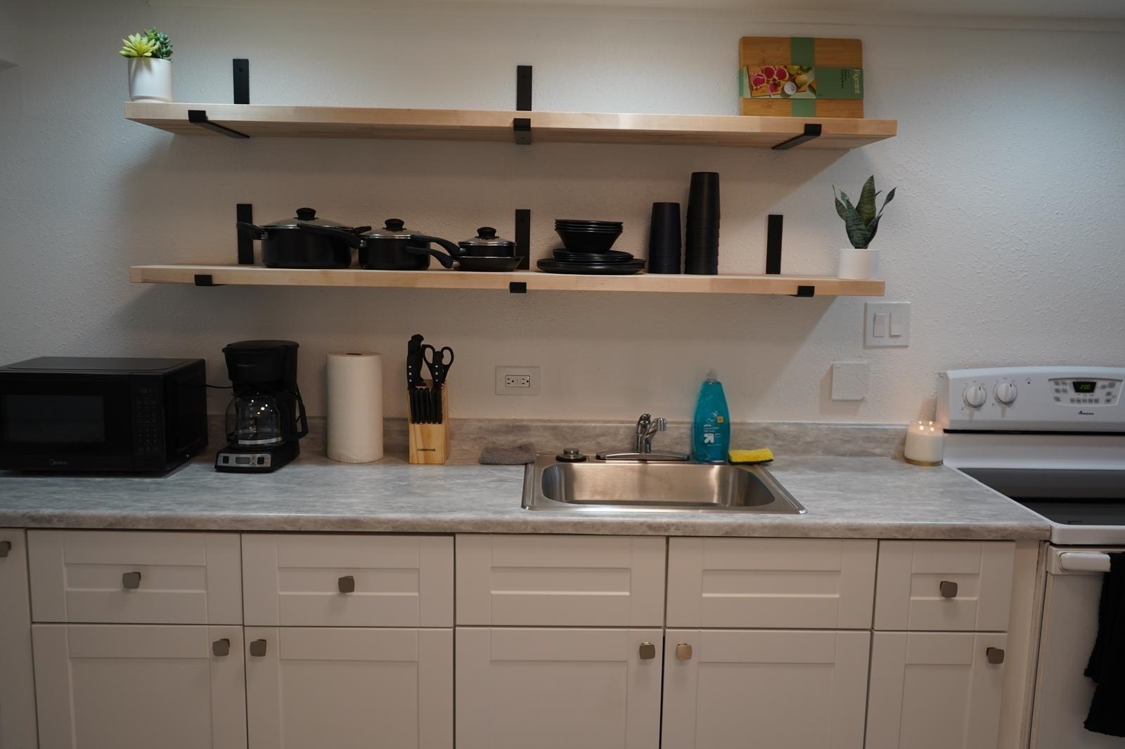 111 Kahului Beach Road, Unit C116 Kahului, HI 96732 - Photo 3 of 14 a kitchen with white cabinets and a sink