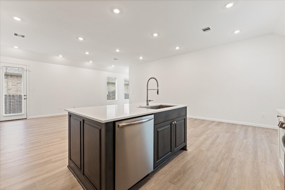 15520 Sunset Maple Court Conroe, TX 77302 - Photo 14 of 47 a kitchen with sink stove and wooden floor