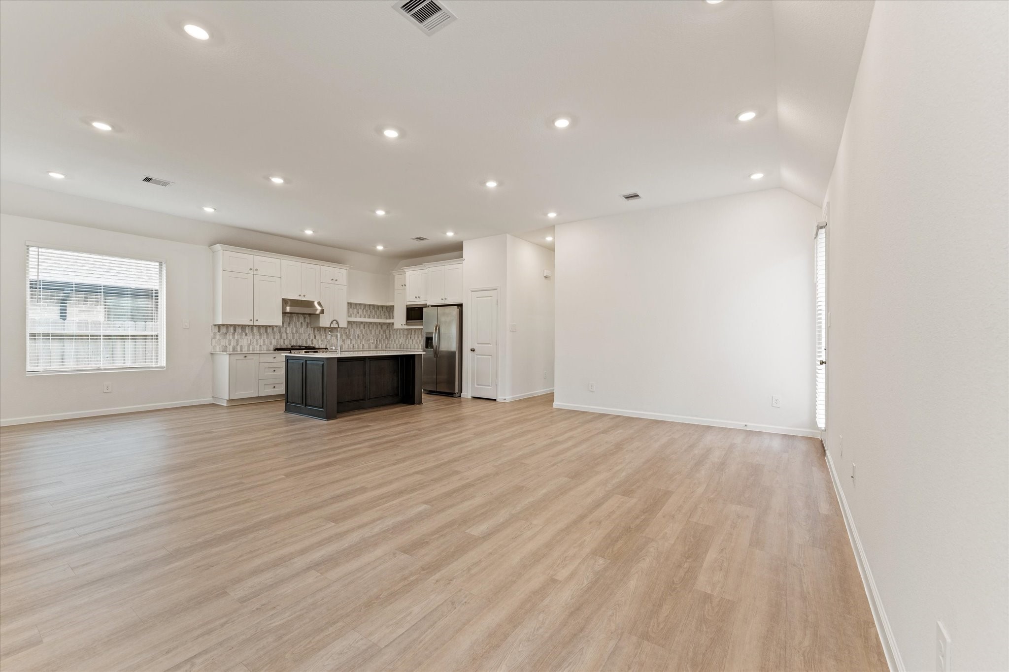 15520 Sunset Maple Court Conroe, TX 77302 - Photo 8 of 47 a view of an empty room with a window and kitchen view