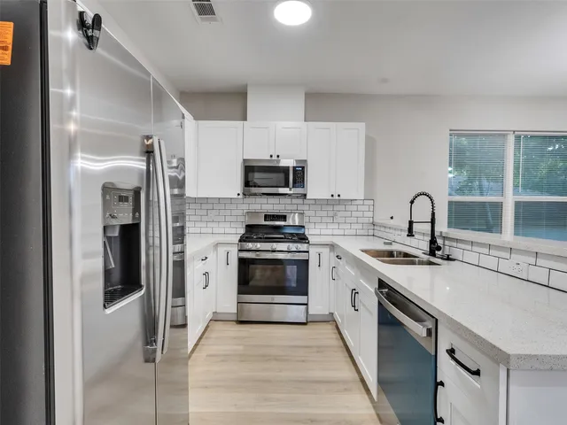 a kitchen with a sink stove and refrigerator