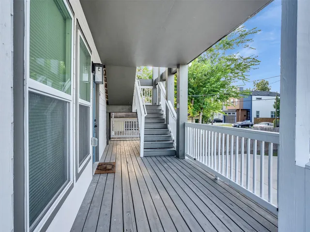 a view of a balcony with wooden floor