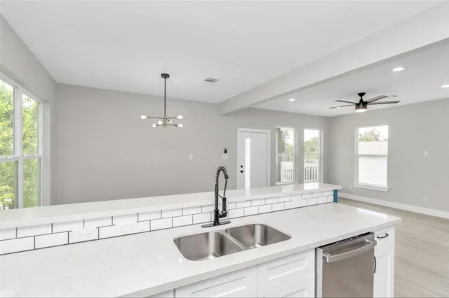 a kitchen with stainless steel appliances granite countertop a sink and dishwasher