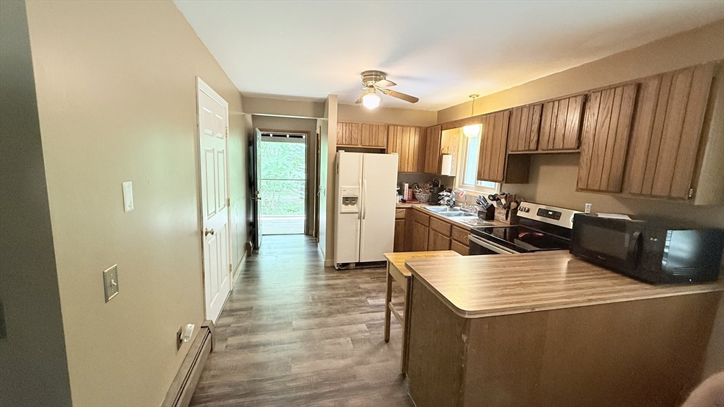 1755 Maple Street Dighton, MA 02764 - Photo 12 of 23 a kitchen with a refrigerator sink and cabinets