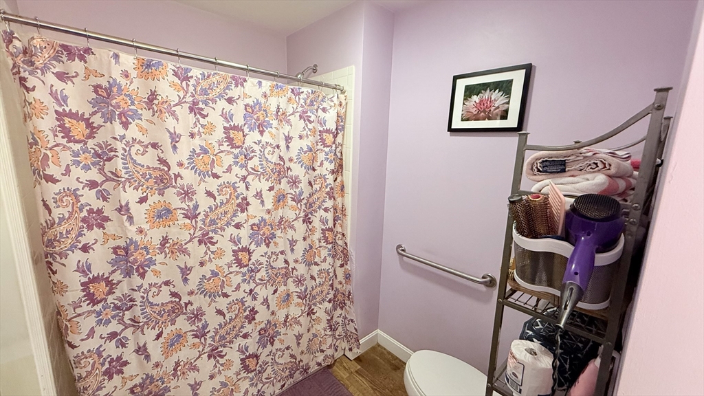 1755 Maple Street Dighton, MA 02764 - Photo 15 of 23 a bathroom with a toilet and a shower curtain