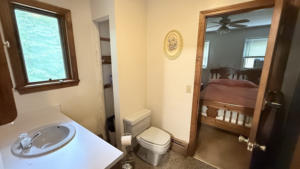 1755 Maple Street Dighton, MA 02764 - Photo 17 of 23 a bathroom with a toilet a sink and a mirror