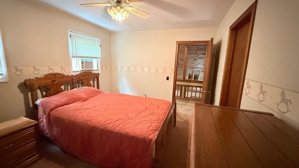 1755 Maple Street Dighton, MA 02764 - Photo 18 of 23 a bedroom with a bed and a chandelier