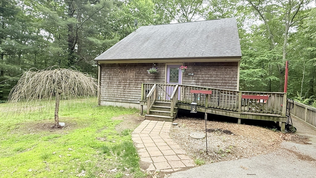 1755 Maple Street Dighton, MA 02764 - Photo 2 of 23 a backyard of a house with barbeque oven and garden