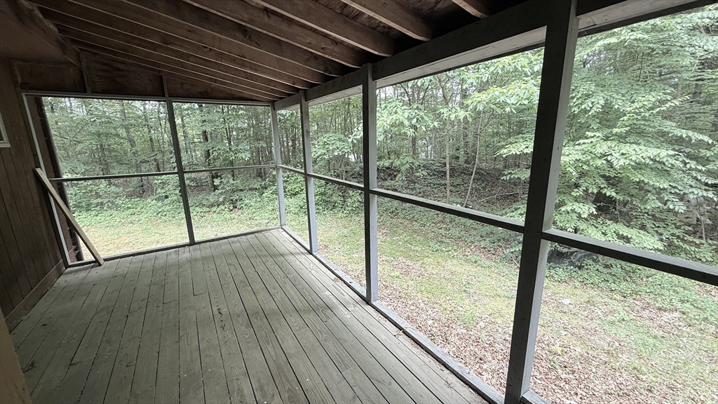 1755 Maple Street Dighton, MA 02764 - Photo 5 of 23 a view of empty room with wooden floor and iron stairs
