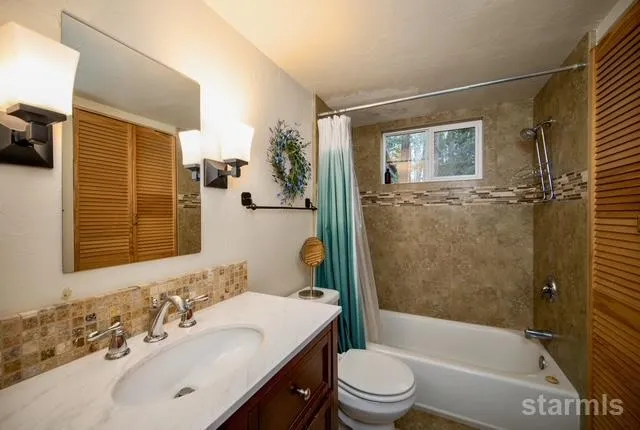 a front view of a house with garden and sitting area