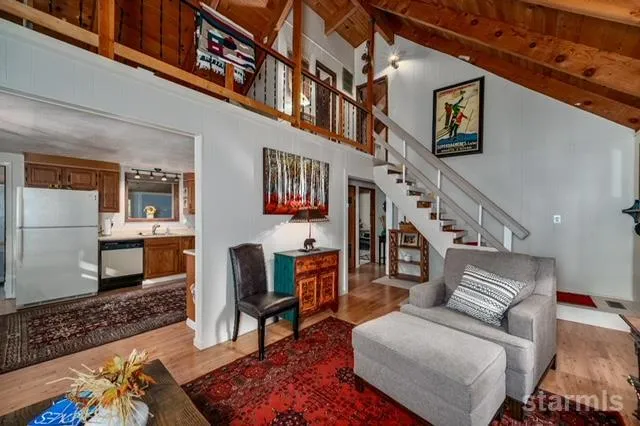 a living room with furniture large window and a fireplace