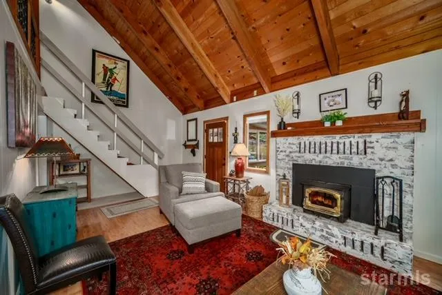 a living room with furniture a fireplace and a table