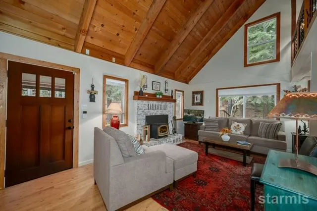 a backyard of a house with wooden floor and outdoor seating