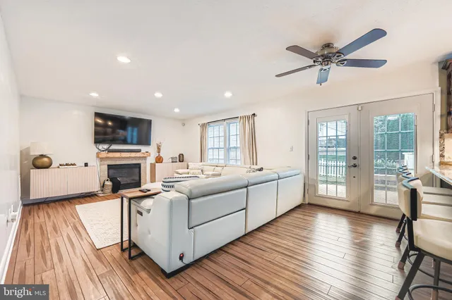 a large white kitchen with a large window a sink and stainless steel appliances