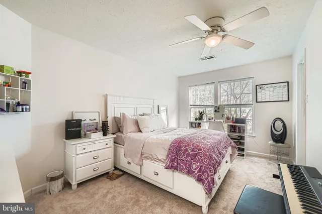 a bedroom with a bed a couch and dresser