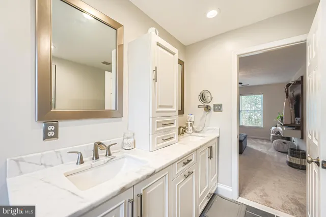 a bathroom with double vanity sinks and a mirror