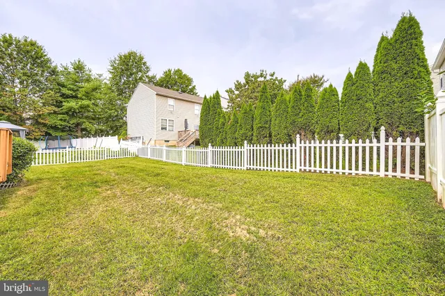 a view of a backyard with a garden and entertaining space