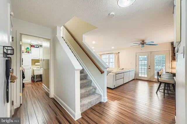 a view of entryway and hall with wooden floor