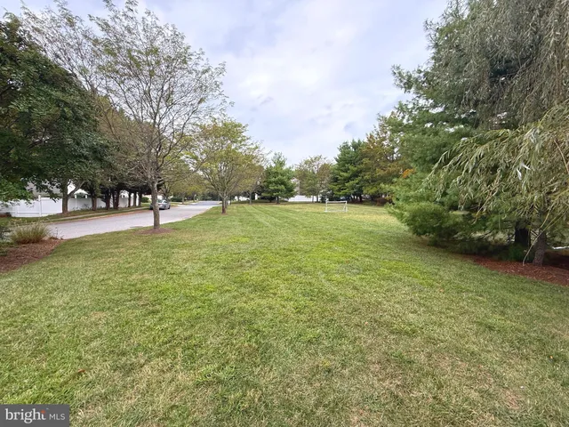 a view of a field with an trees in the background