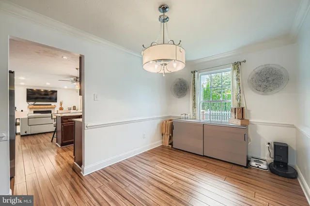 a kitchen with a refrigerator and a stove top oven