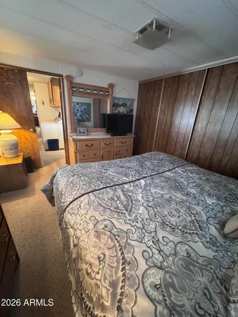 a bed sitting in a spacious bedroom next to a window