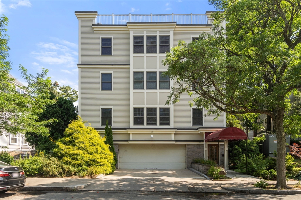 121 Centre Street, Unit PH3 Brookline, MA 02446 - Photo 1 of 32 a front view of a house with a yard