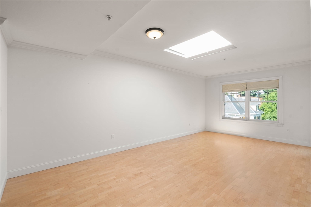 121 Centre Street, Unit PH3 Brookline, MA 02446 - Photo 11 of 32 an empty room with windows