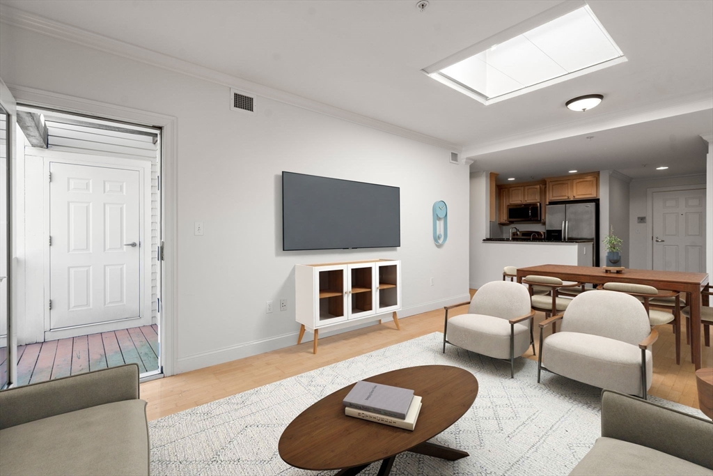 121 Centre Street, Unit PH3 Brookline, MA 02446 - Photo 12 of 32 a living room with furniture and a flat screen tv