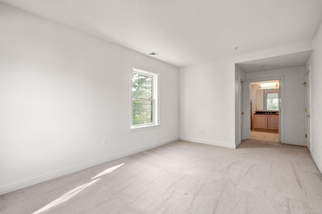 121 Centre Street, Unit PH3 Brookline, MA 02446 - Photo 15 of 32 an empty room with windows and closet