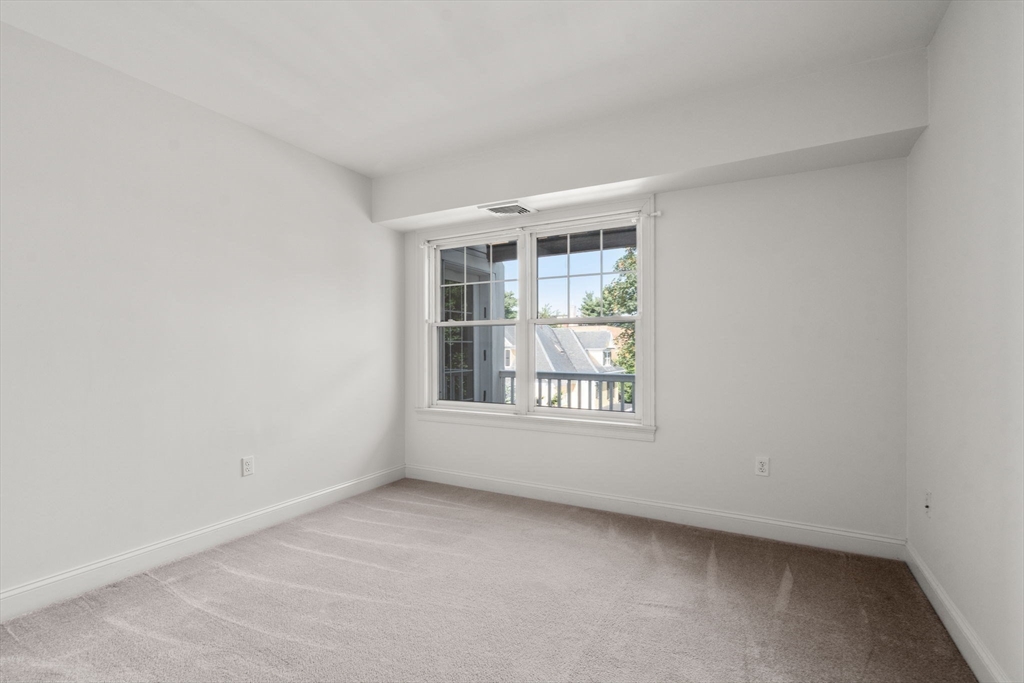 121 Centre Street, Unit PH3 Brookline, MA 02446 - Photo 17 of 32 an empty room with a window