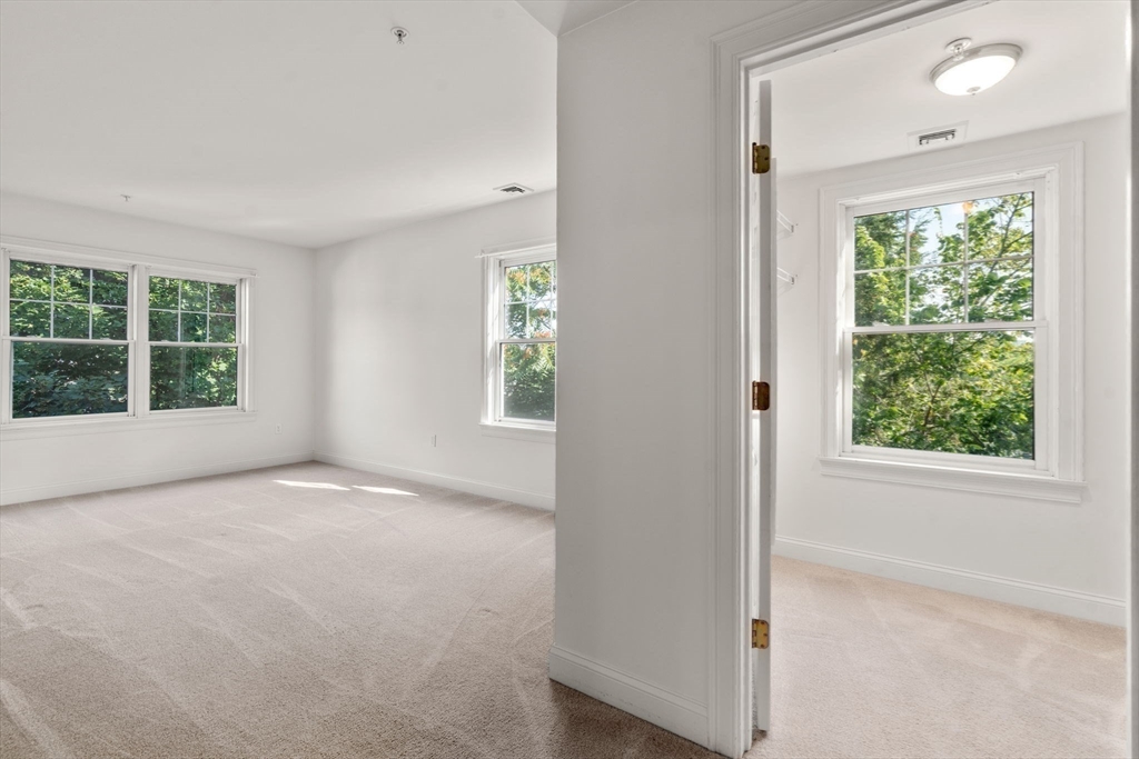 121 Centre Street, Unit PH3 Brookline, MA 02446 - Photo 18 of 32 an empty room with windows