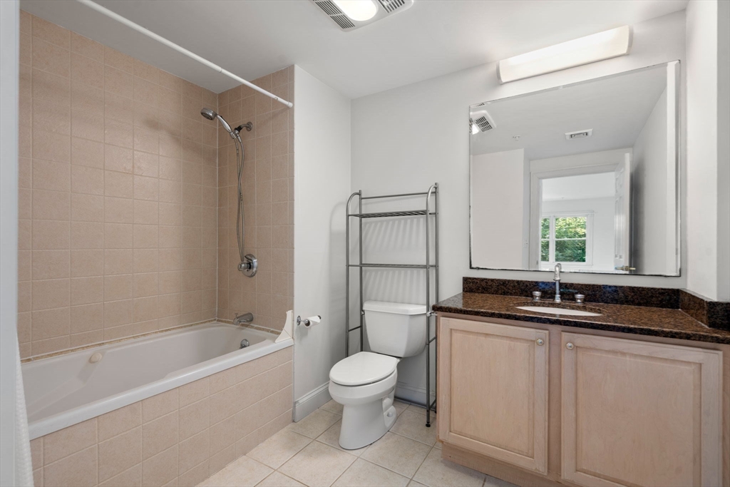 121 Centre Street, Unit PH3 Brookline, MA 02446 - Photo 20 of 32 a bathroom with a granite countertop sink a toilet and a bathtub