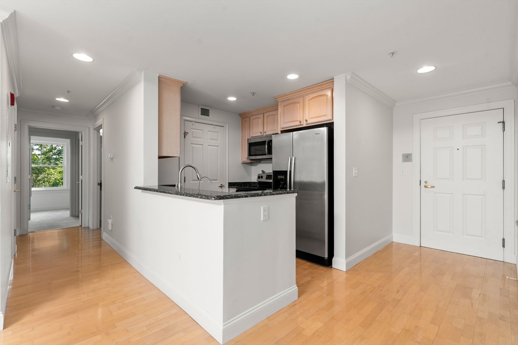 121 Centre Street, Unit PH3 Brookline, MA 02446 - Photo 2 of 32 a kitchen with stainless steel appliances granite countertop a refrigerator and a stove
