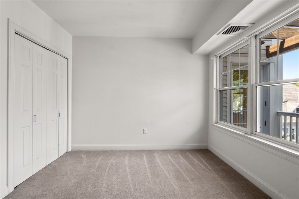 121 Centre Street, Unit PH3 Brookline, MA 02446 - Photo 23 of 32 a view of an empty room with a window